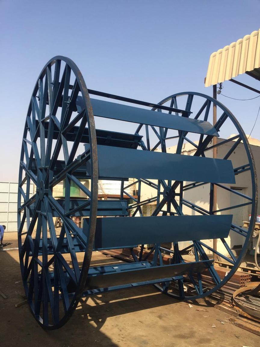Large blue fabricated cable drum frame in the yard